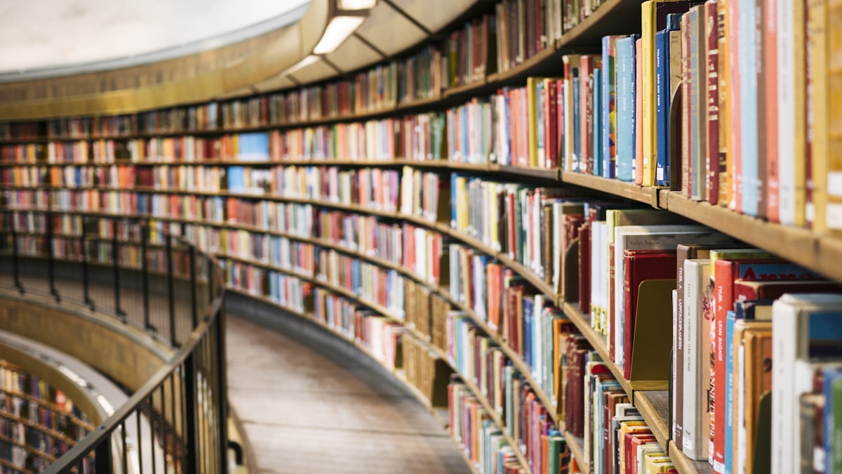 Curved bookshelves in a library filled with books